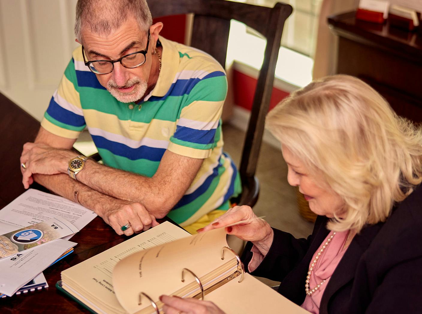 female attorney showing documents to her male client