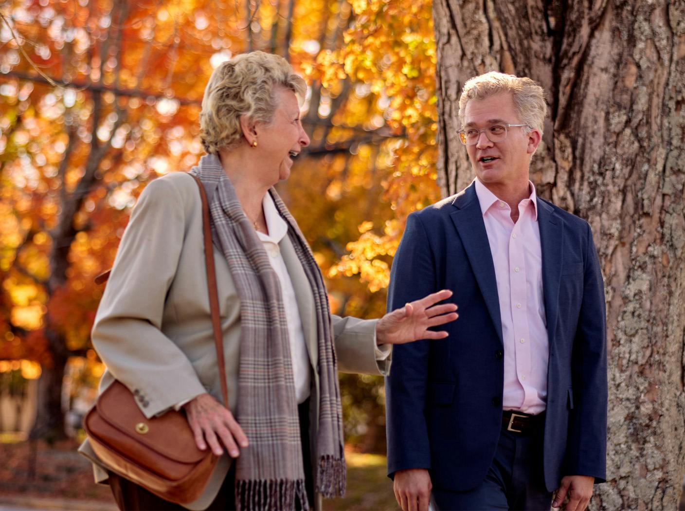 attorney and woman walking and talking outside