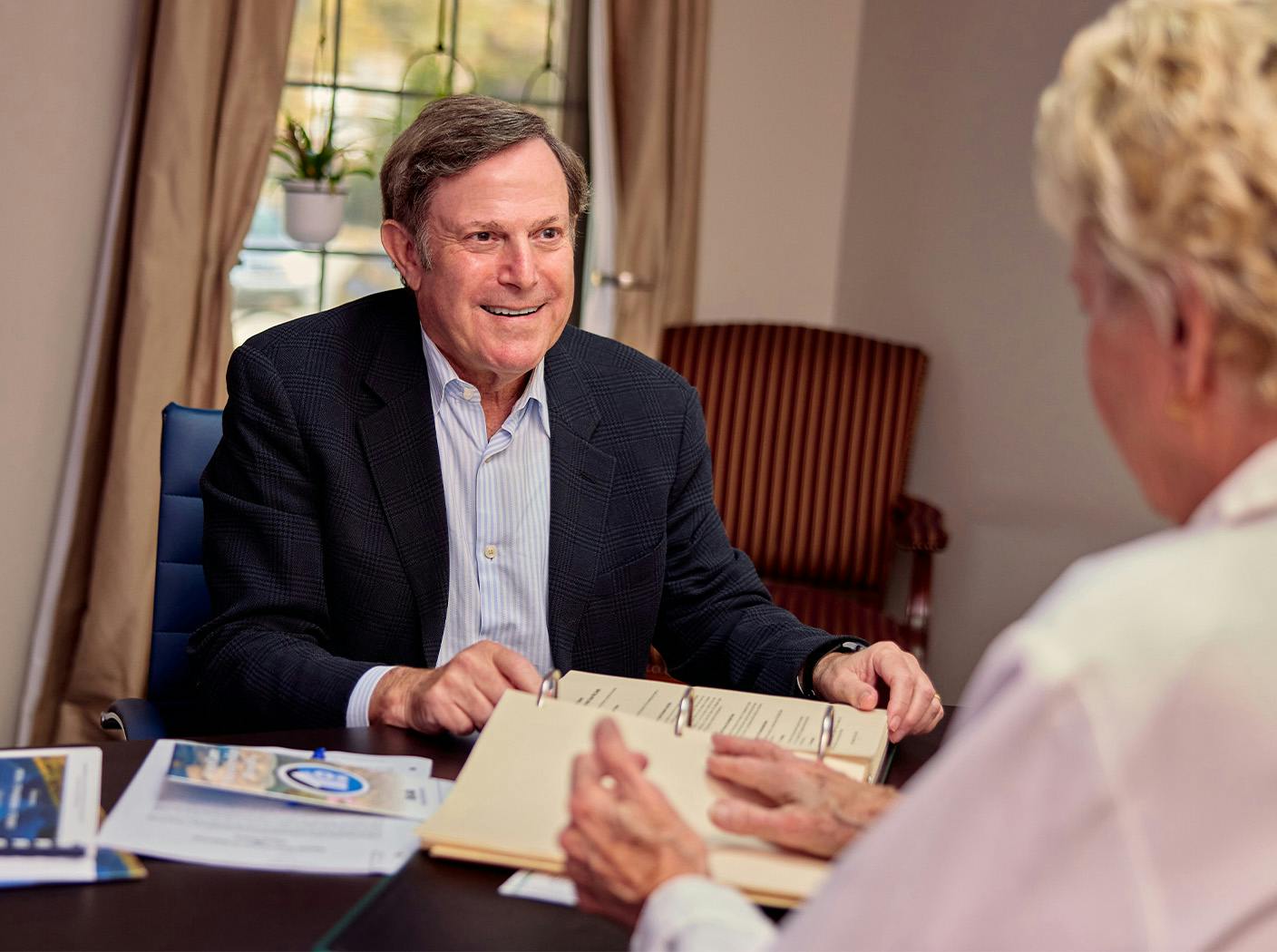 man sitting down and looking at client across from him