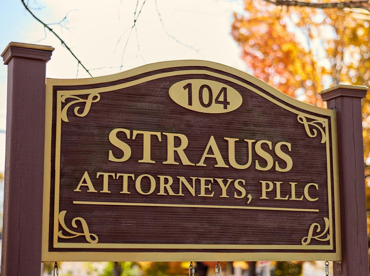 Strauss Law wooden sign outside