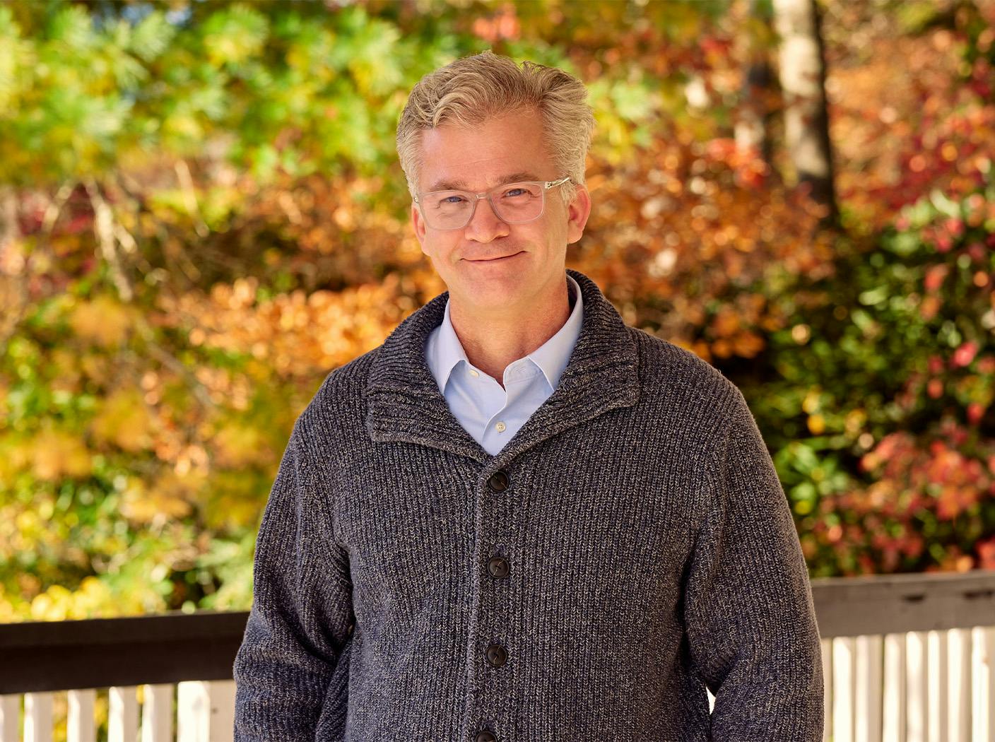 Brad Henry in gray cardigan smiling