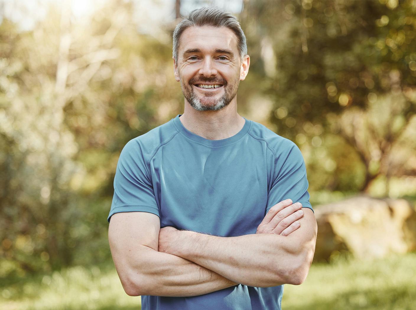 Man smiling with arms crossed