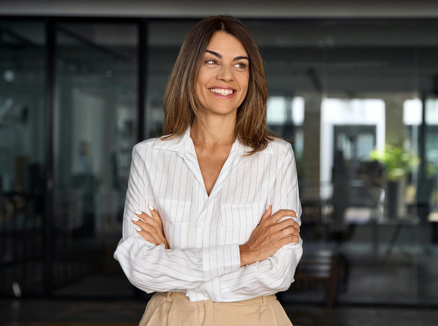 woman in white long sleeve crossing her arms and smiling