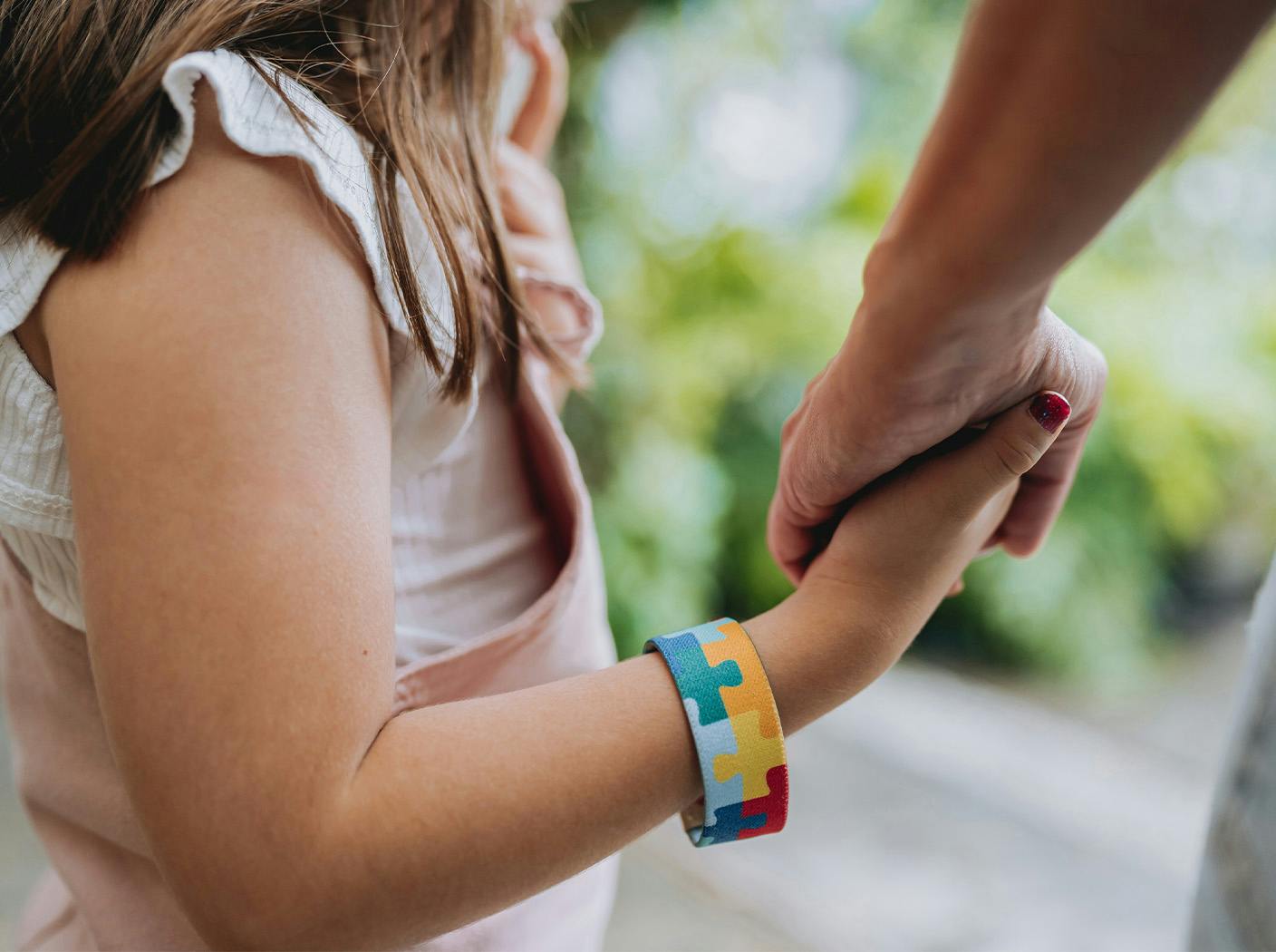 child holding parent's hand close up