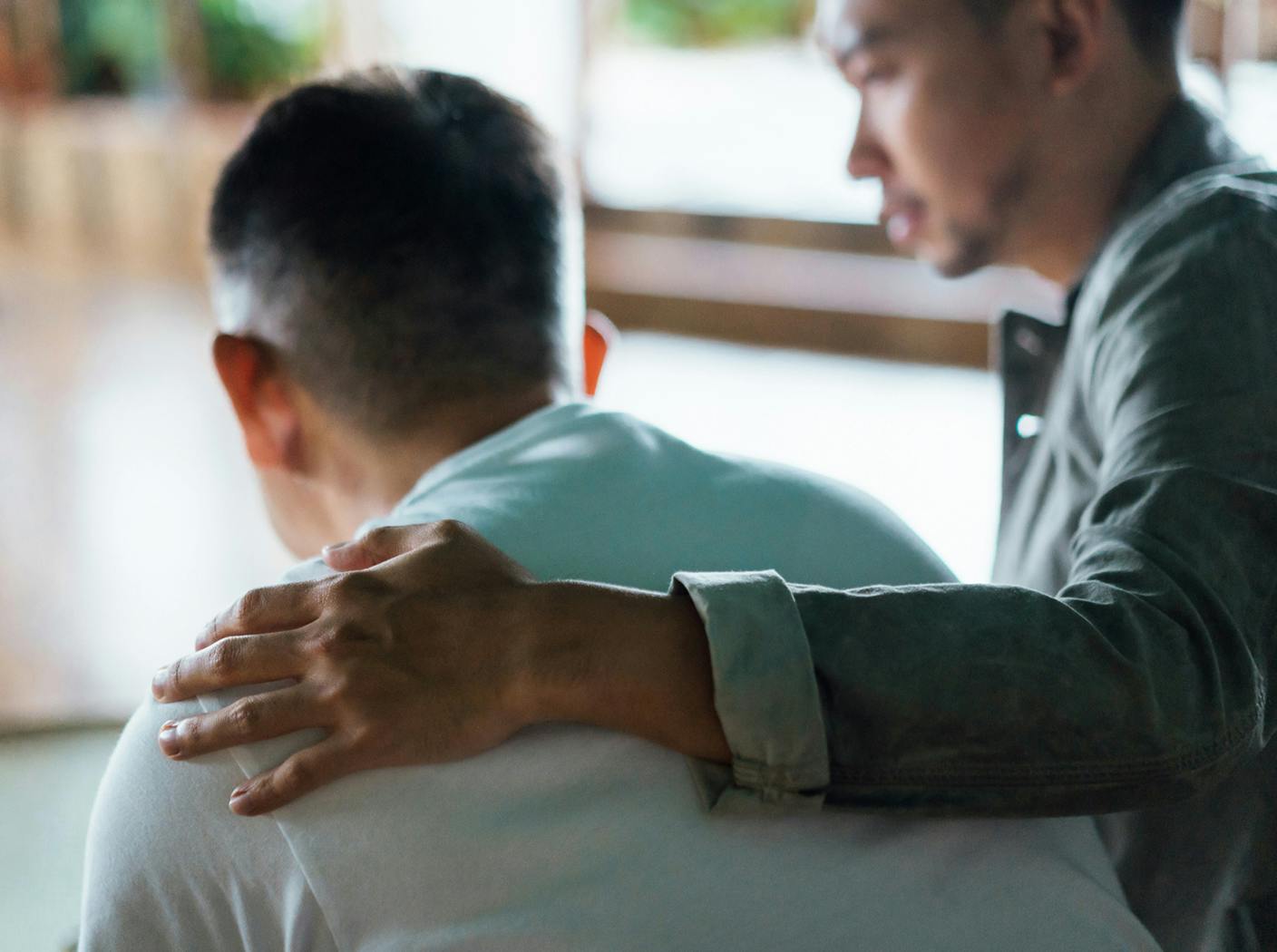 man with his arm around another man