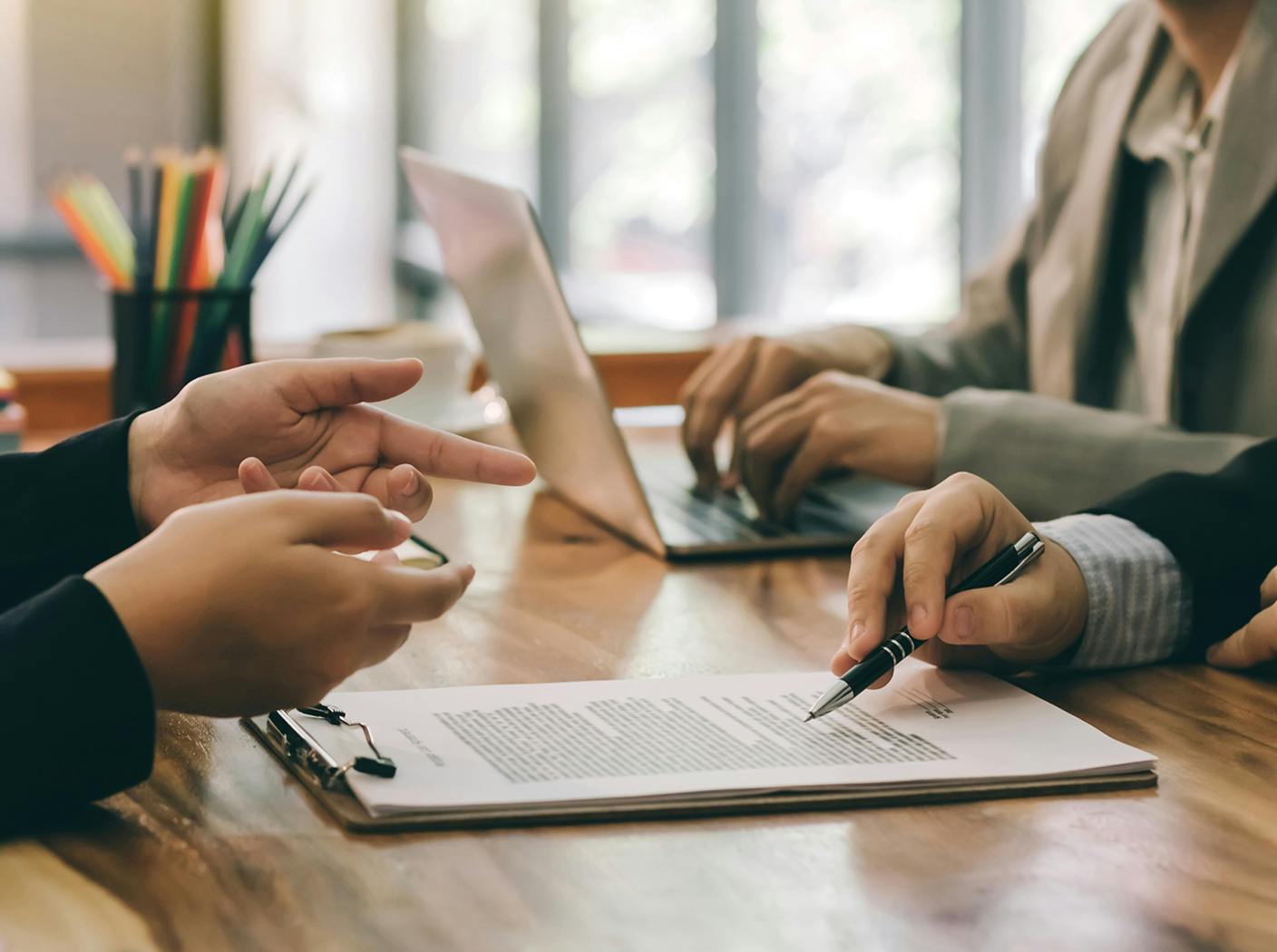 people at desk going over paperwork