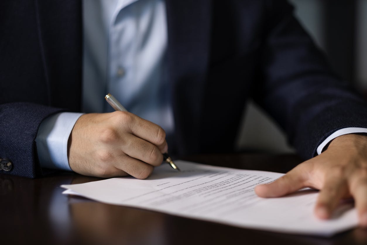 A man signing paperwork