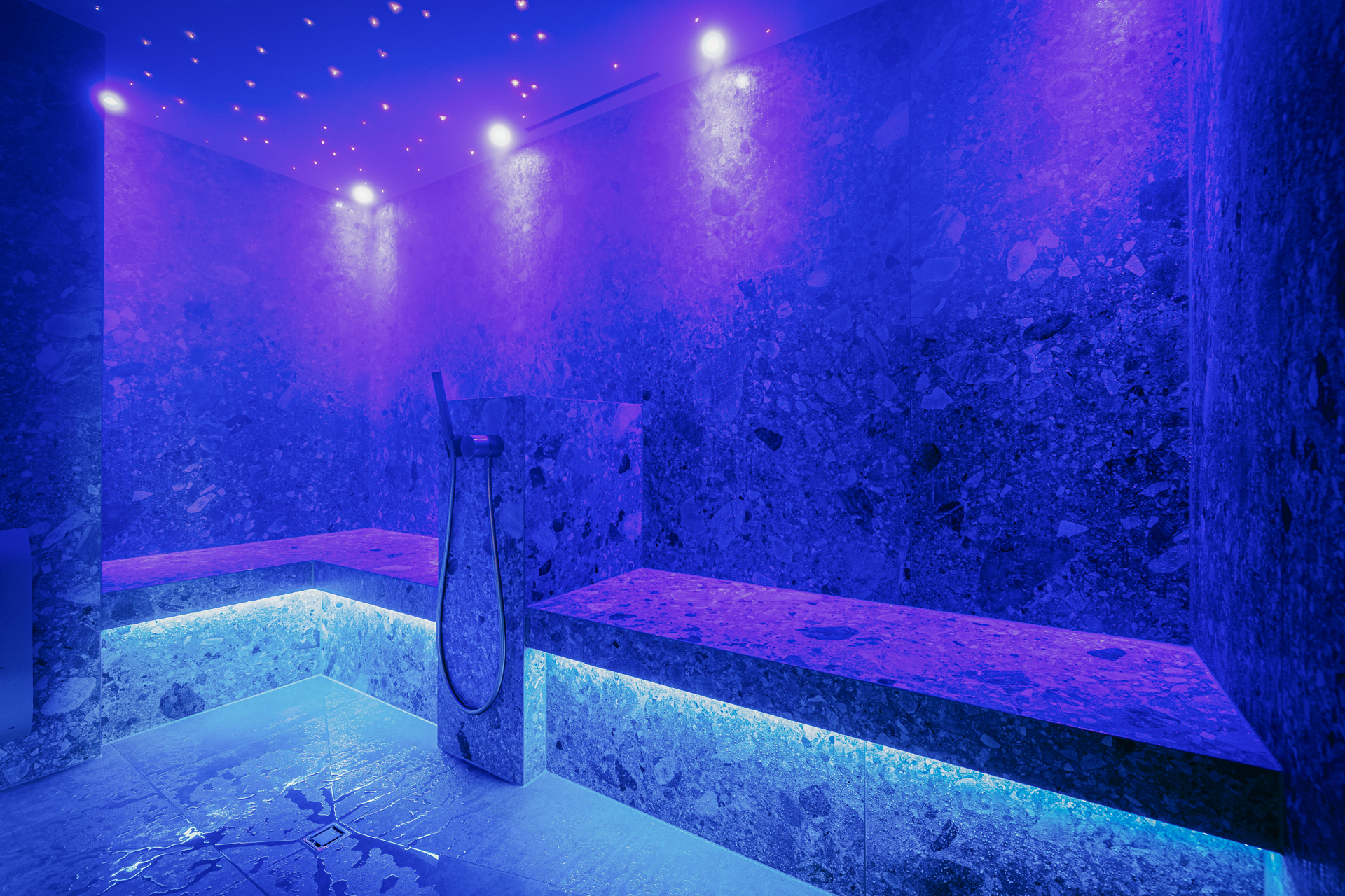 Lightning blue illuminated marble steam bath with shower hose