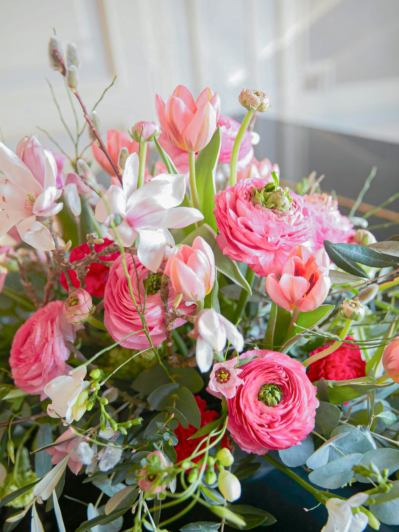 Flower arrangement from BEATUS Floristry Flower arrangement with pink ranunculus and willow catkins