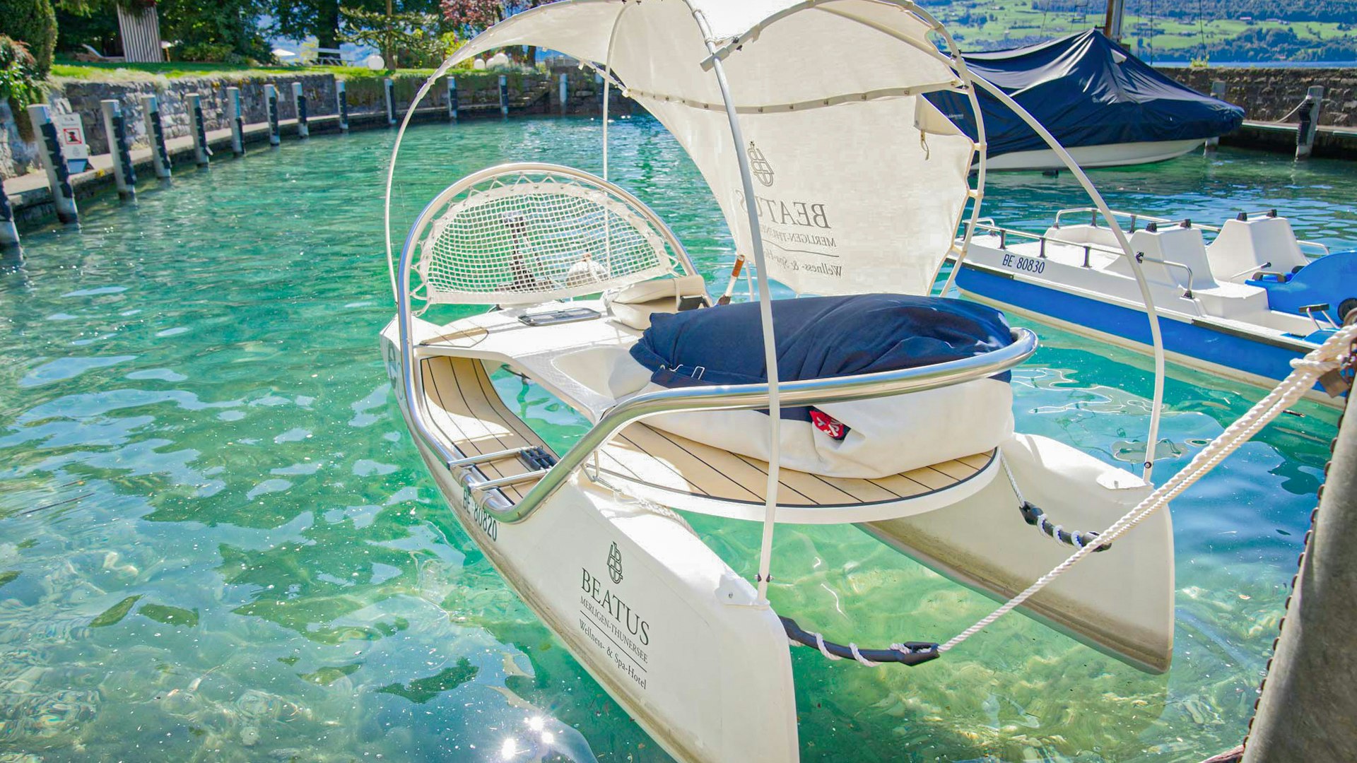 Water sports at Hotel BEATUS A small catamaran with a sun sail moored in a harbour
