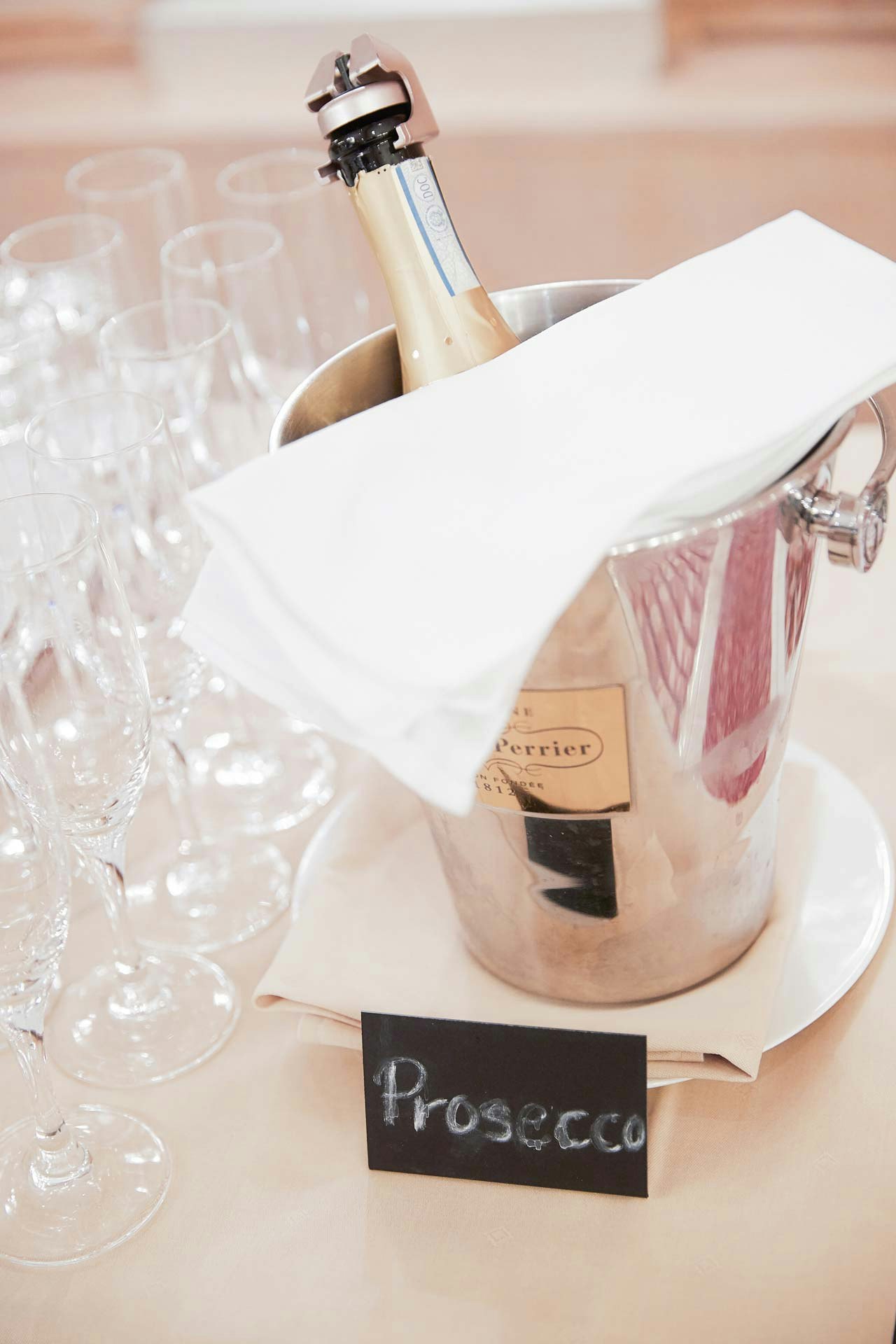 Breakfast buffet with Prosecco bottle in cooler and cloth napkin, glasses next to it