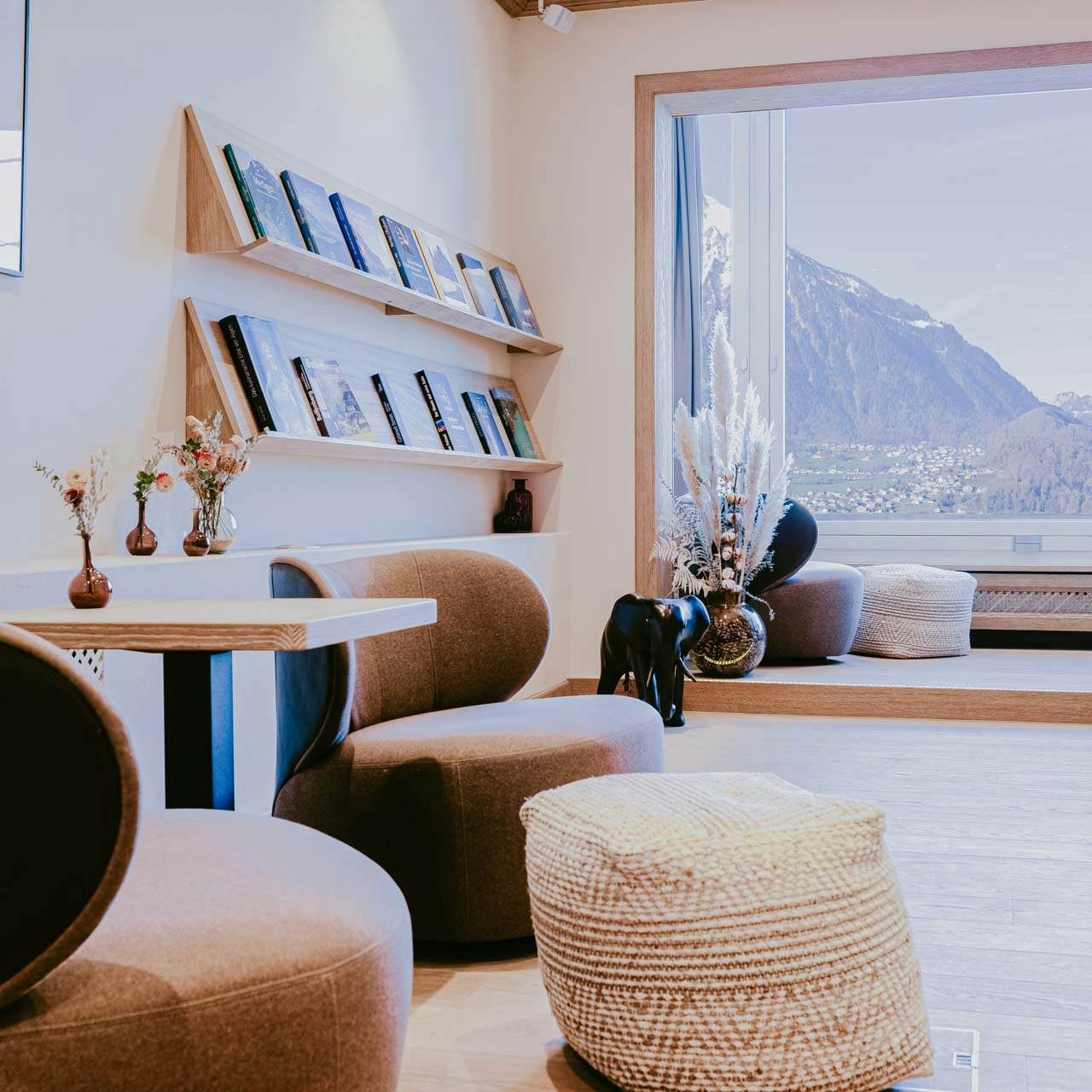 Seminar room at Hotel BEATUS Upholstered furniture and tables, large window with a view of the lake