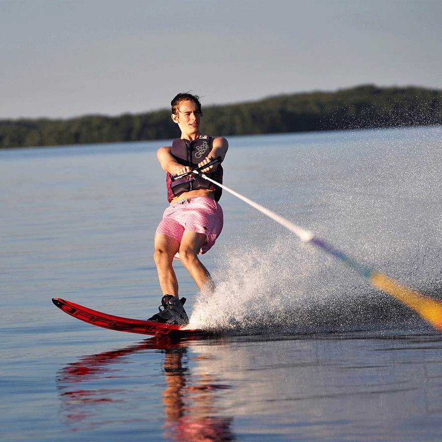 Water skiing on Lake Thun Young woman on a monoski being pulled by a motorboat