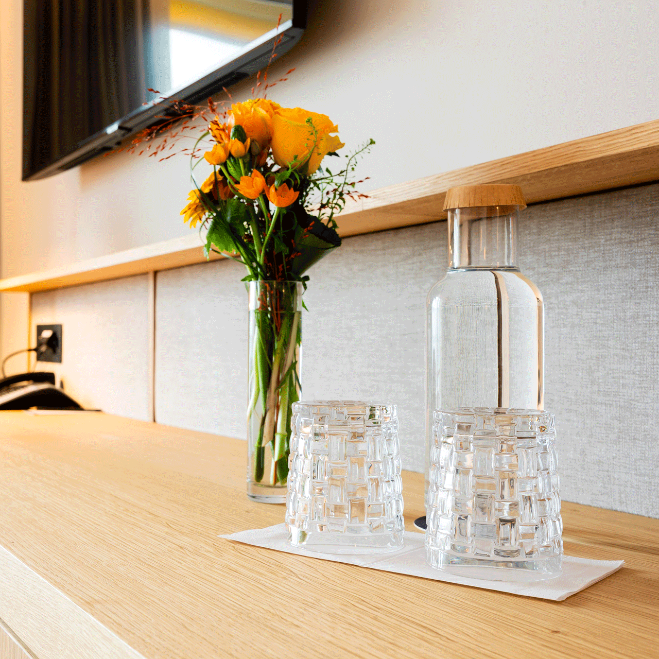 Sustainability at Hotel Beatus Room with table, flowers and a water carafe on it