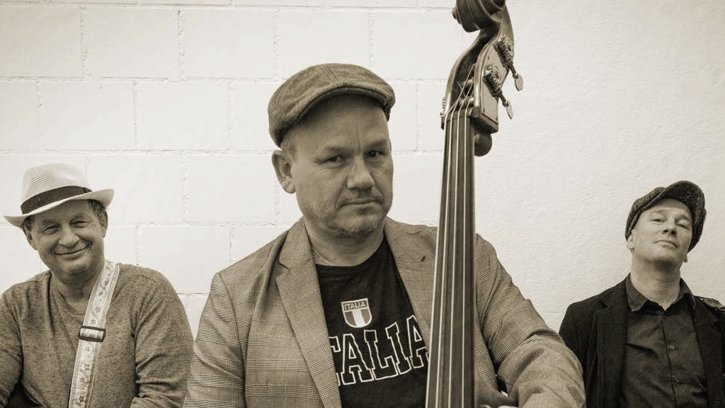 Series of events at the Hotel Beatus Photo in sepia tones of a music trio, in the centre foreground the double bass player with a serious expression