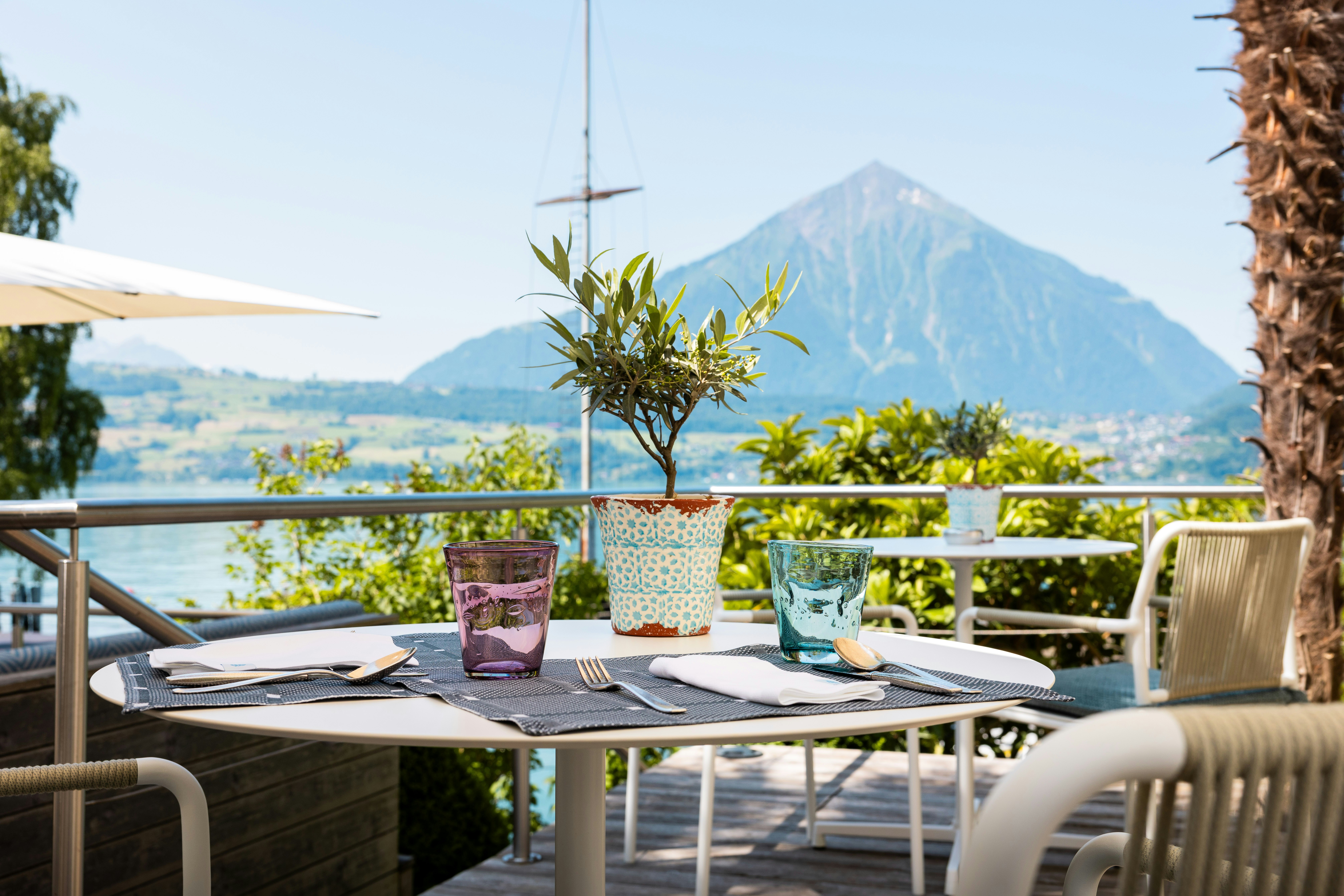 Close-up of a set table with Mount Niesen in the background.