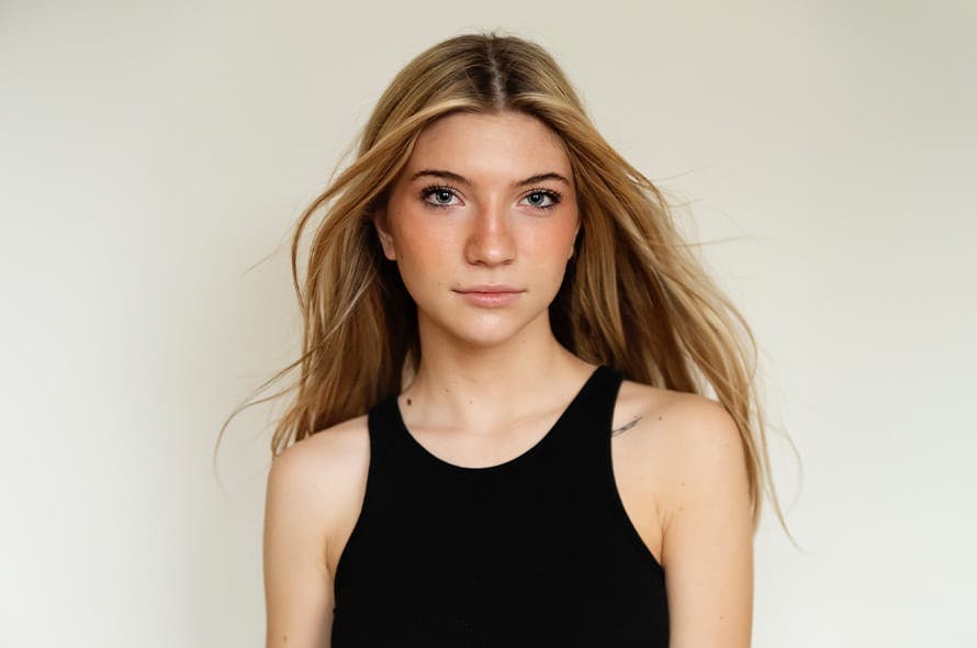 young woman with black tank top looking forward