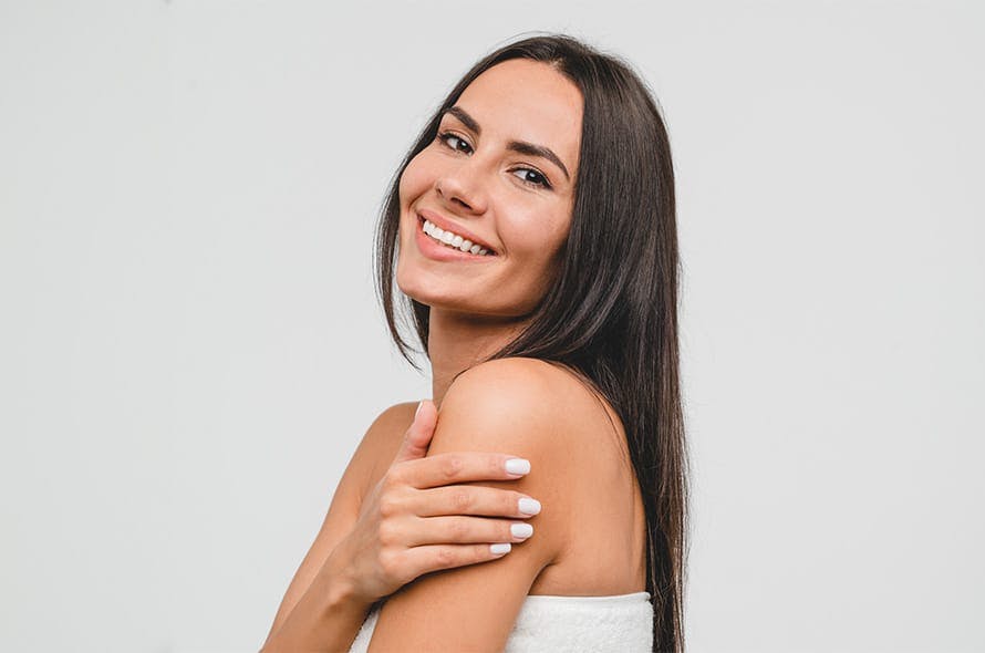 long haired brunette looking forward smile with arms crossed
