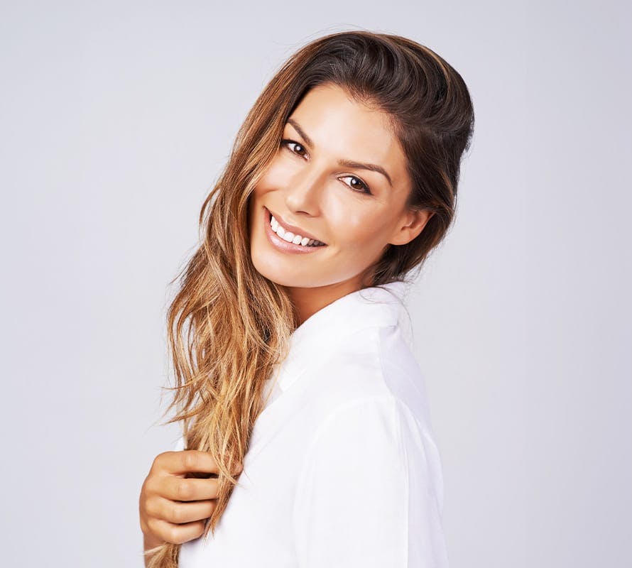 woman tilting her head slightly and smiling