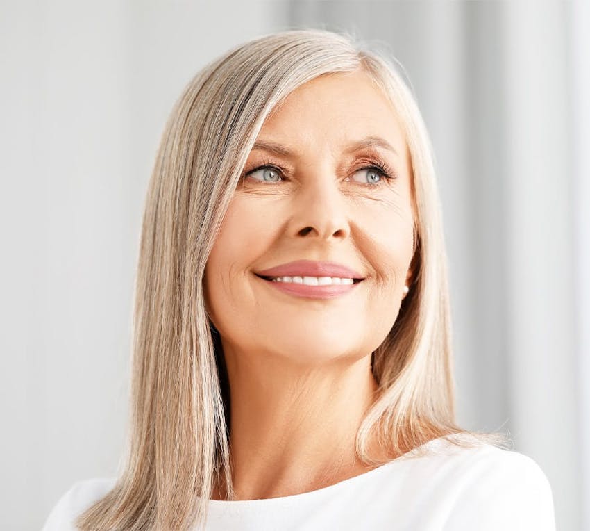 older grey haired woman looking right