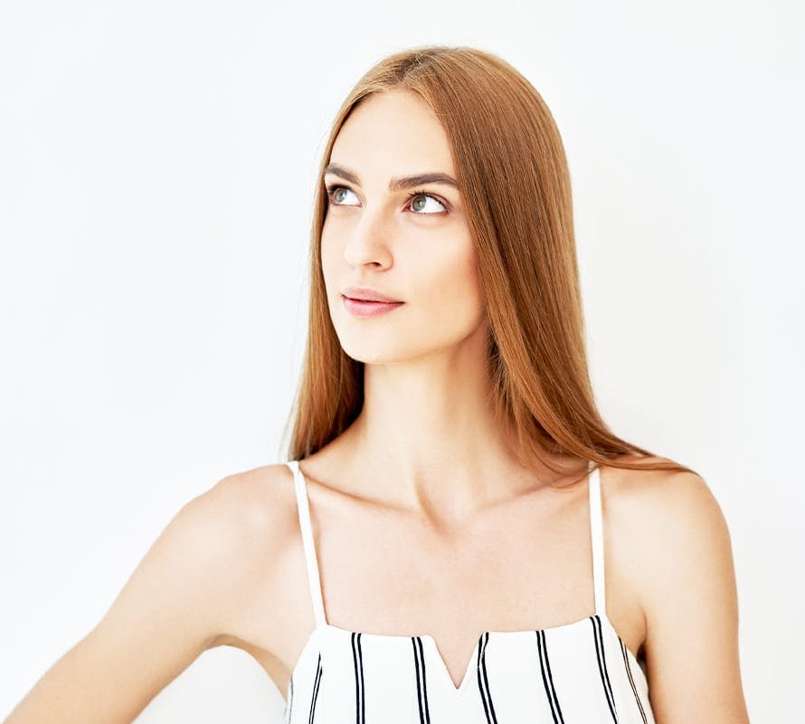 woman with red hair looking upwards