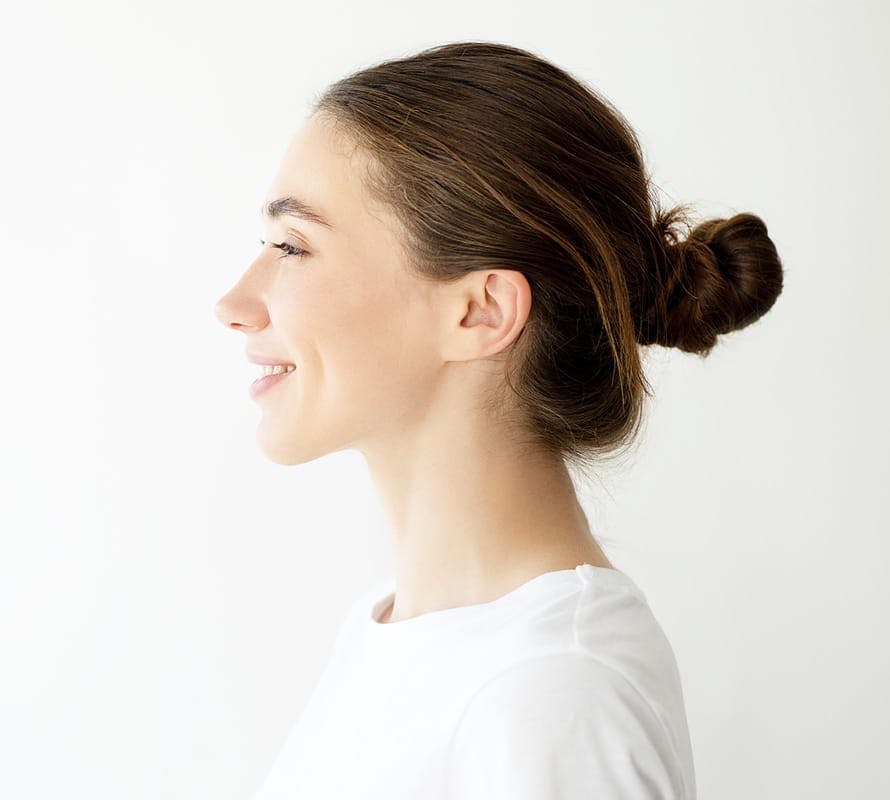 side profile of woman with hair in a bun