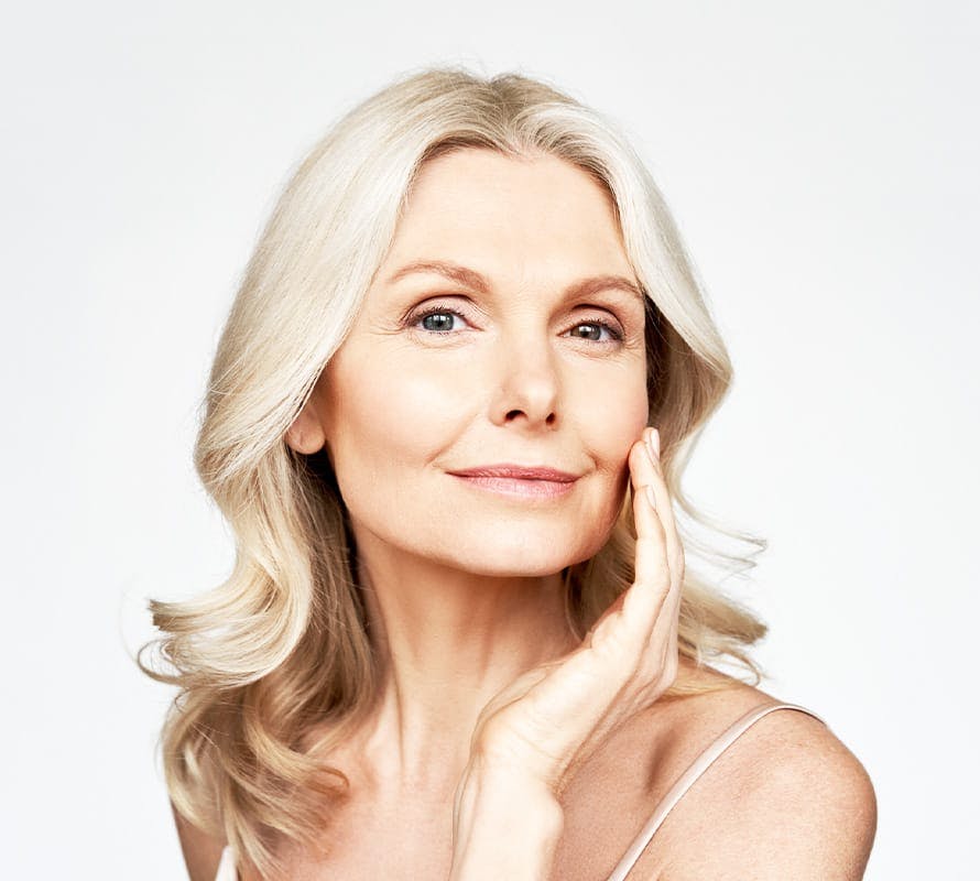 older woman touching her cheek with her hand