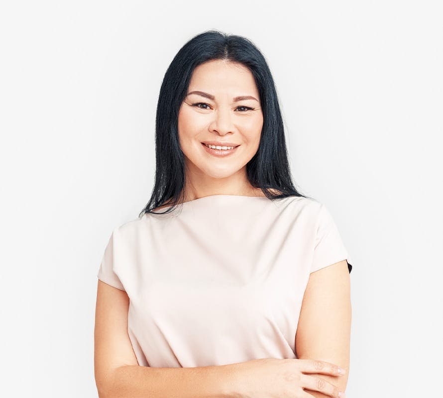 woman with her arms crossed smiling