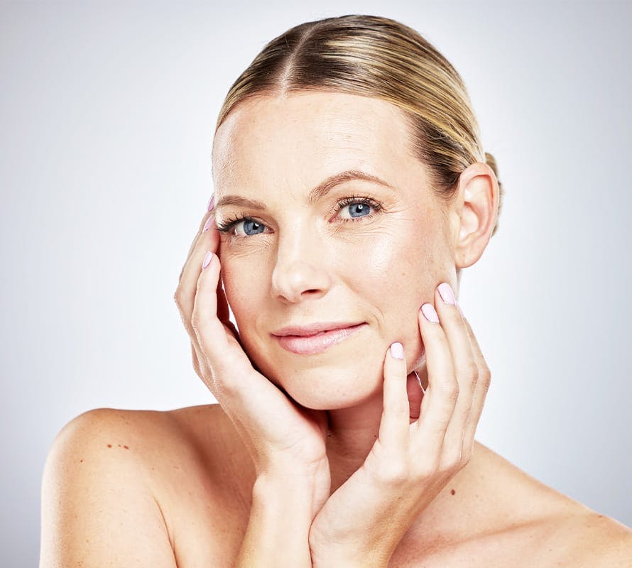 woman with both her hands on her face