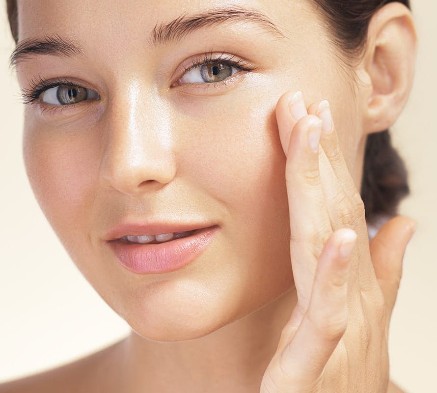 close up of woman touching her cheek