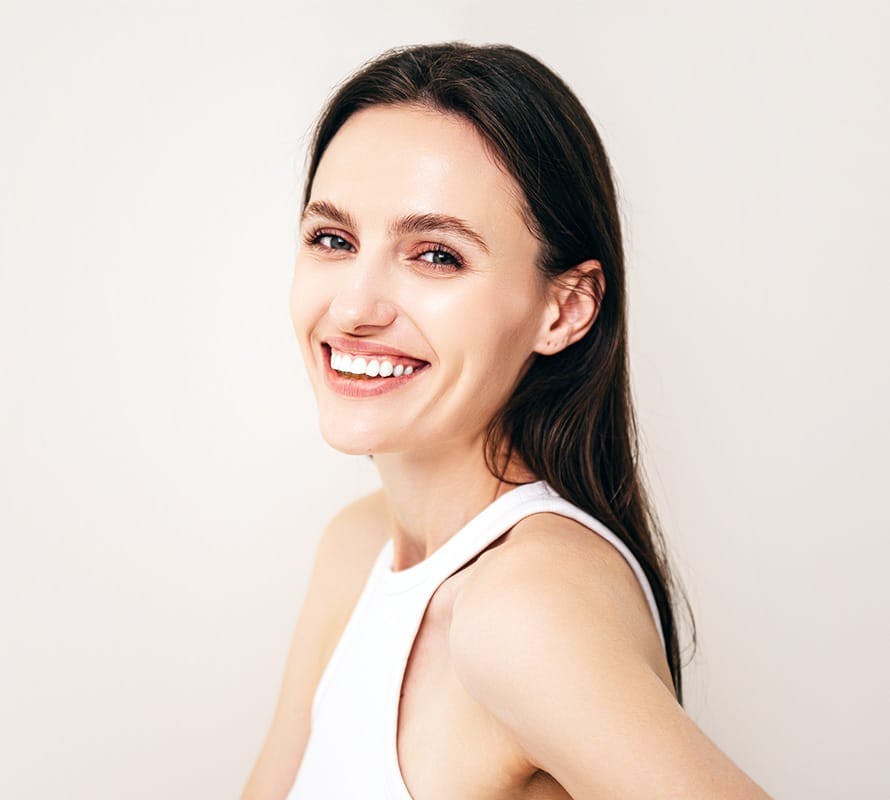 woman facing to the left and smiling with straight black hair
