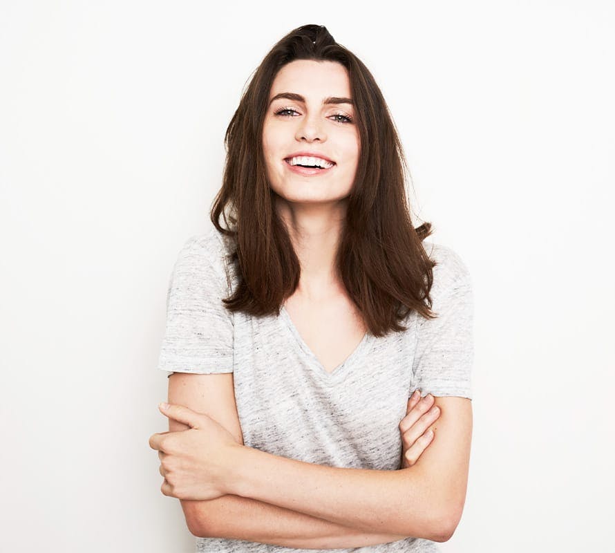 woman smiling while crossing her arms