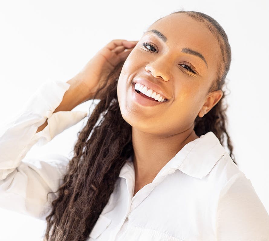 woman smiling with head tilted back