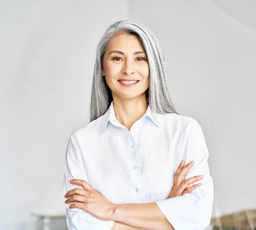 older woman with her arms crossed