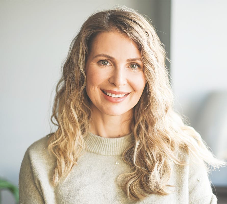 woman with wavy hair smiling