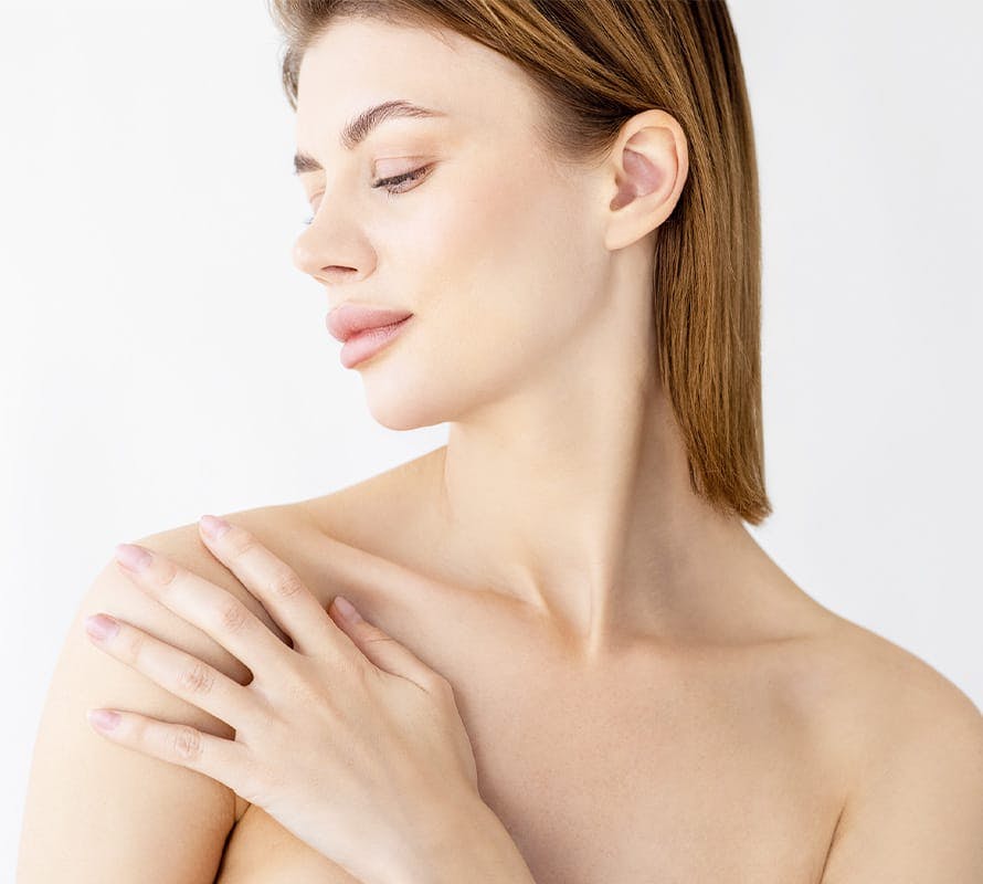 woman looking left touching her own shoulder