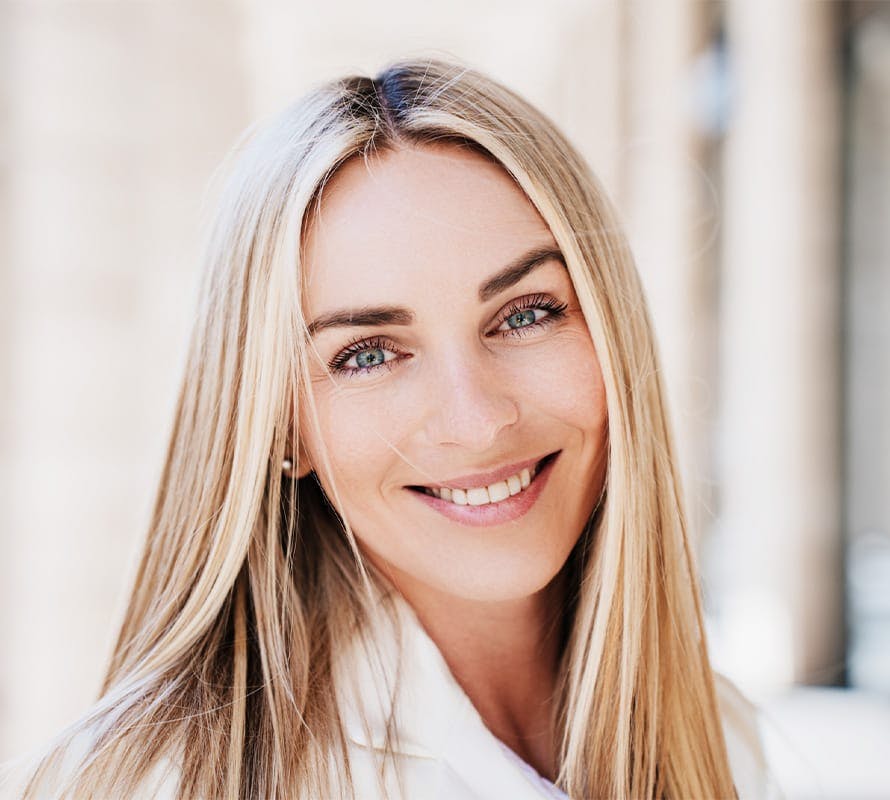 woman with straight blonde hair smiling