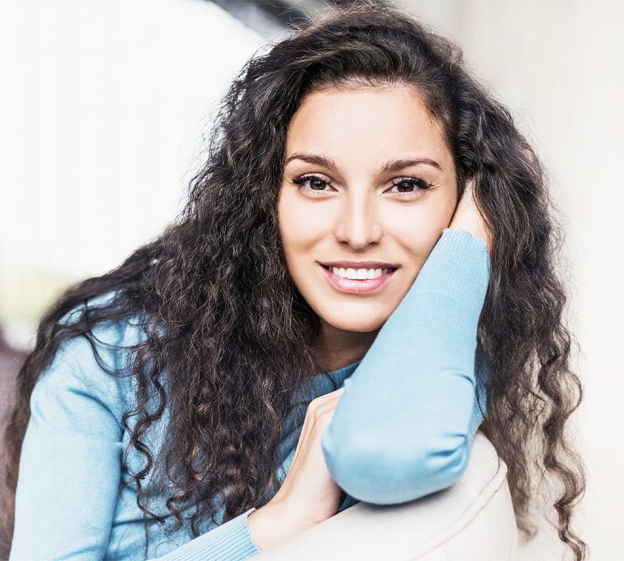 woman on couch leaning on her arm