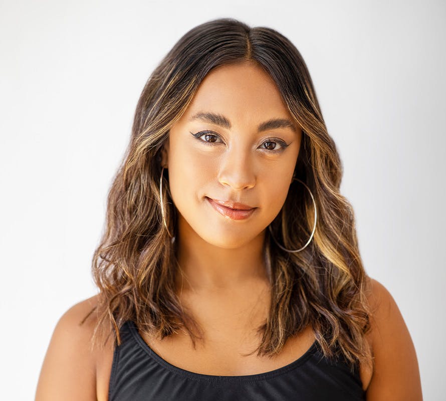 woman looking forward and wearing a black tank top