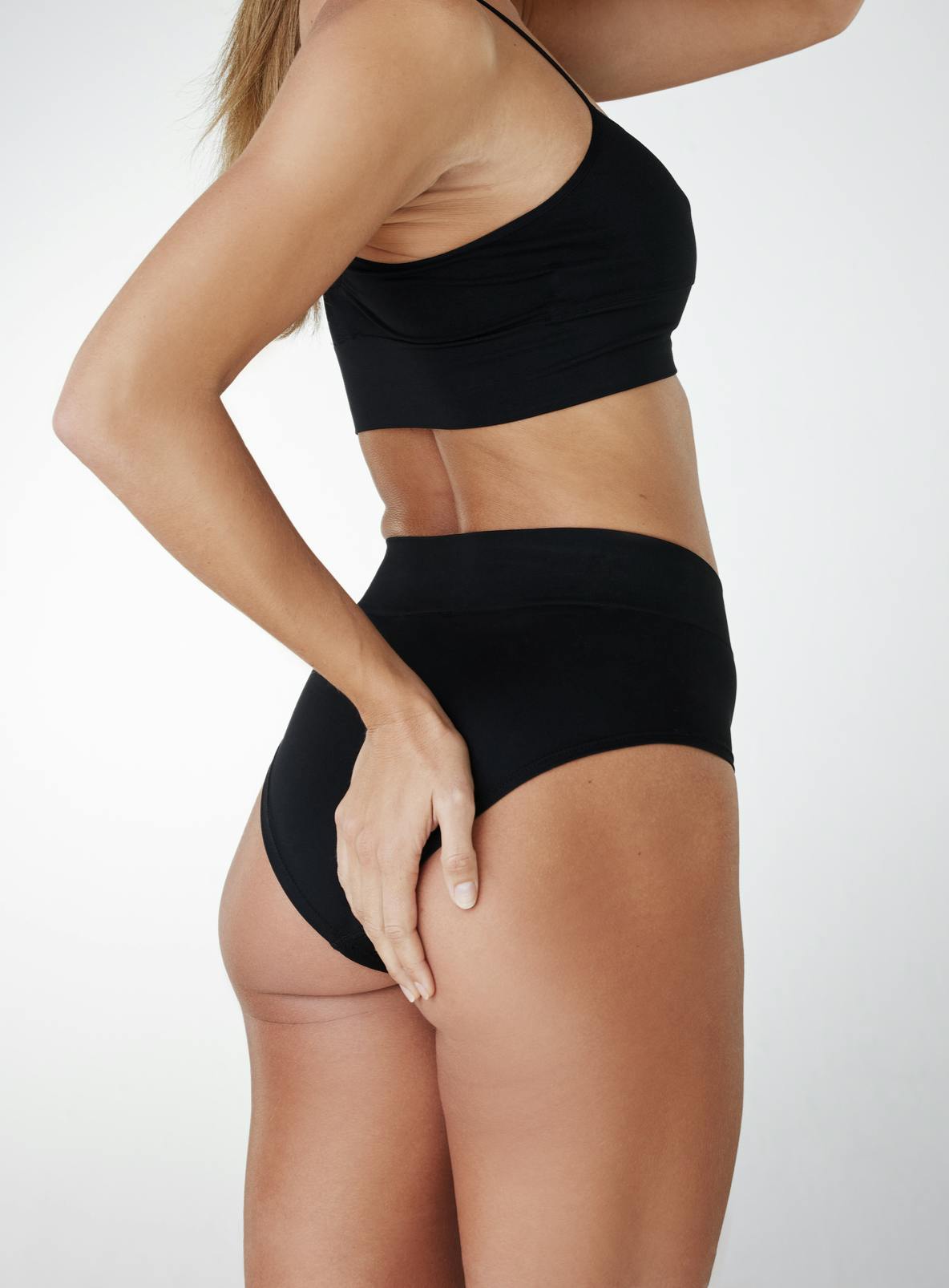 butt and thights of woman in black underwear