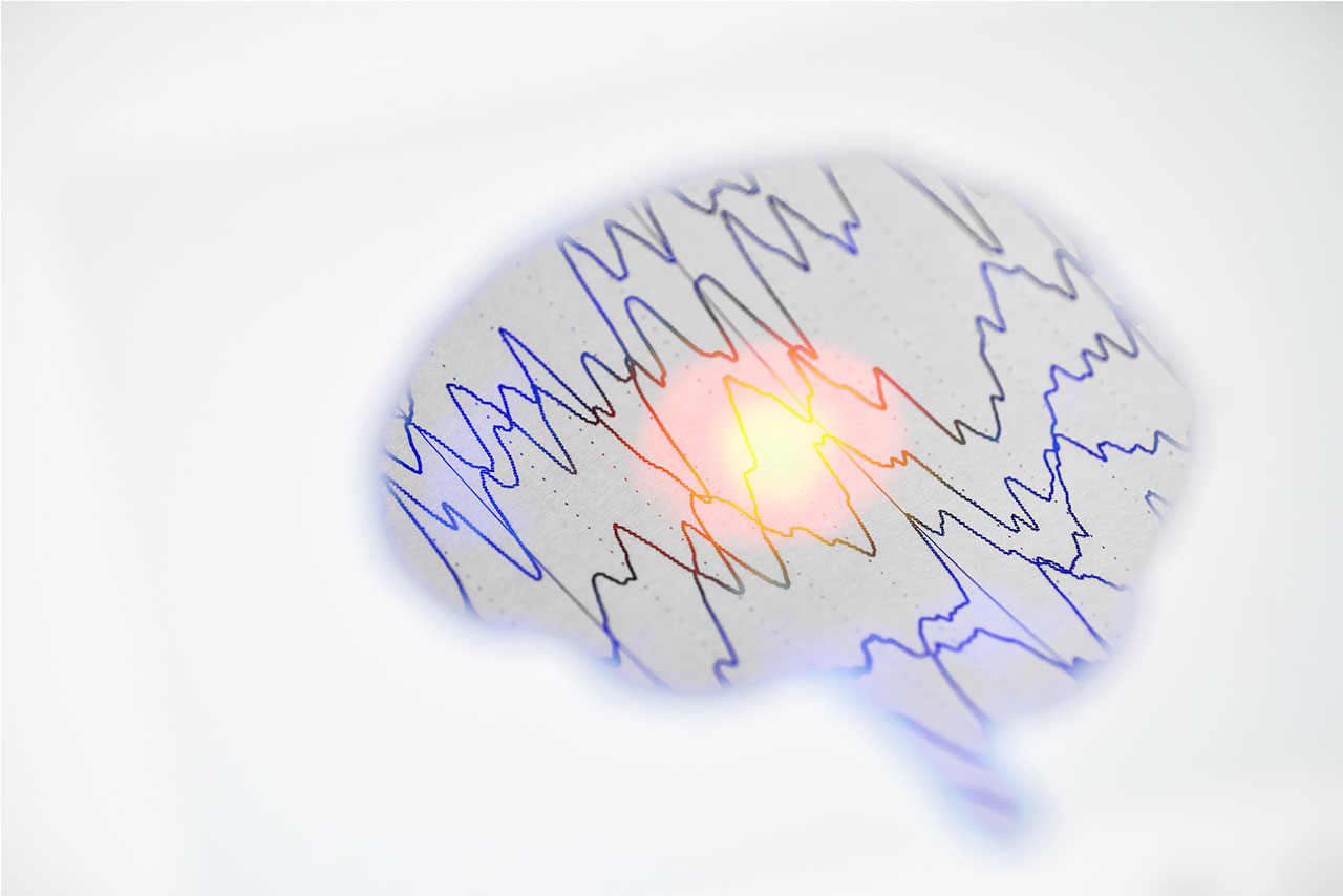 Image of a graphic depicting the brain with brainwaves inside of it