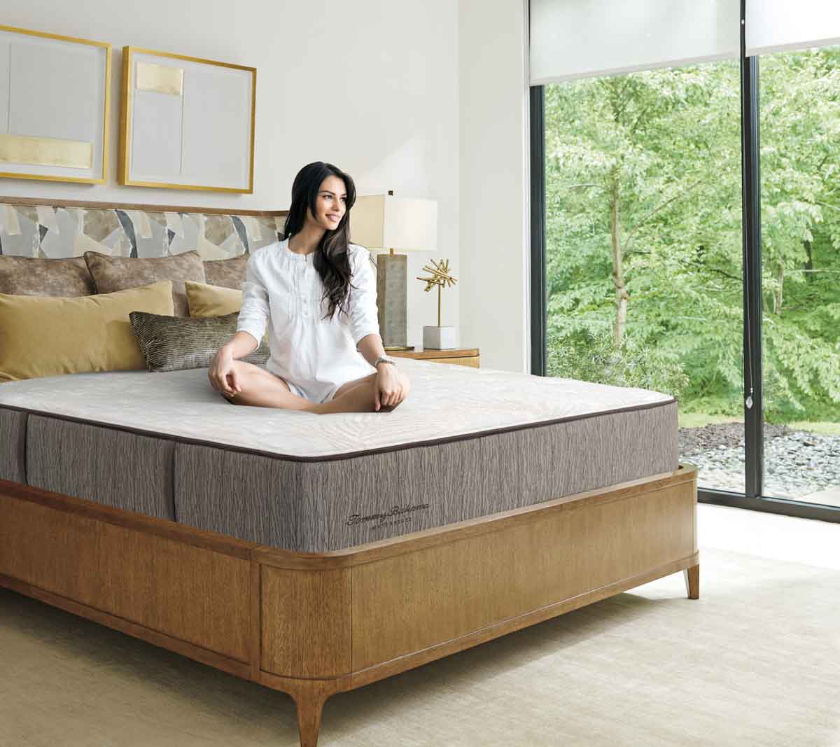 Photo of a woman sitting on her new Tommy Bahama mattress