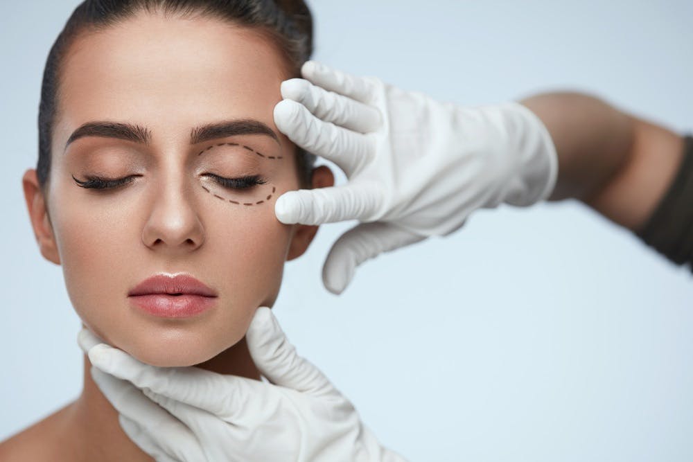 Doctors gloves on a patients face