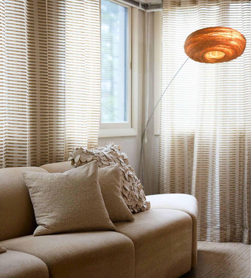 couch with round lamp next to it