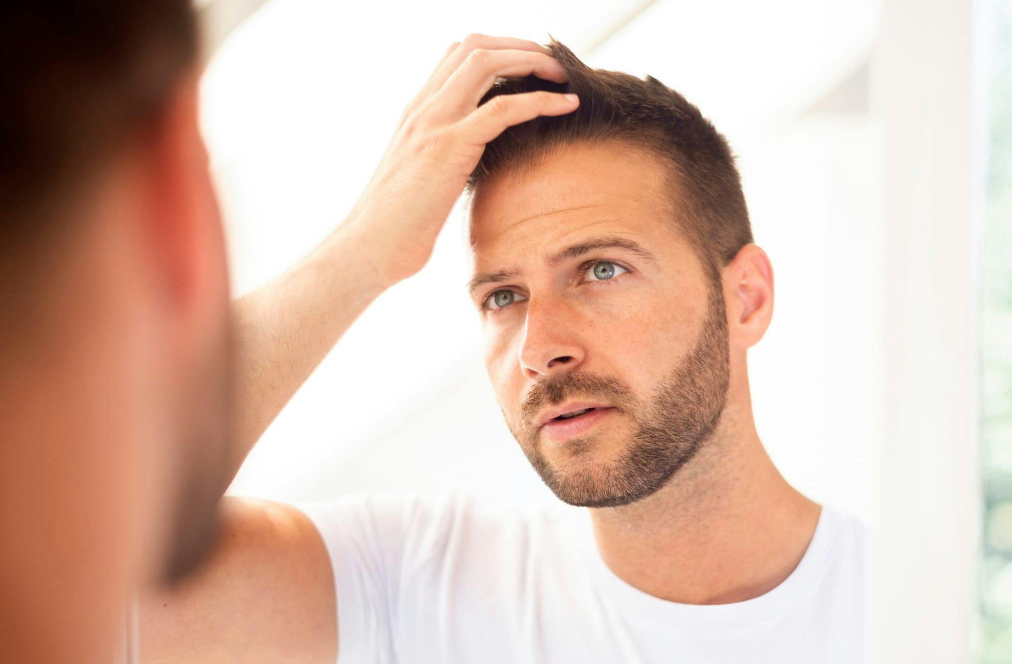 man touching his hair