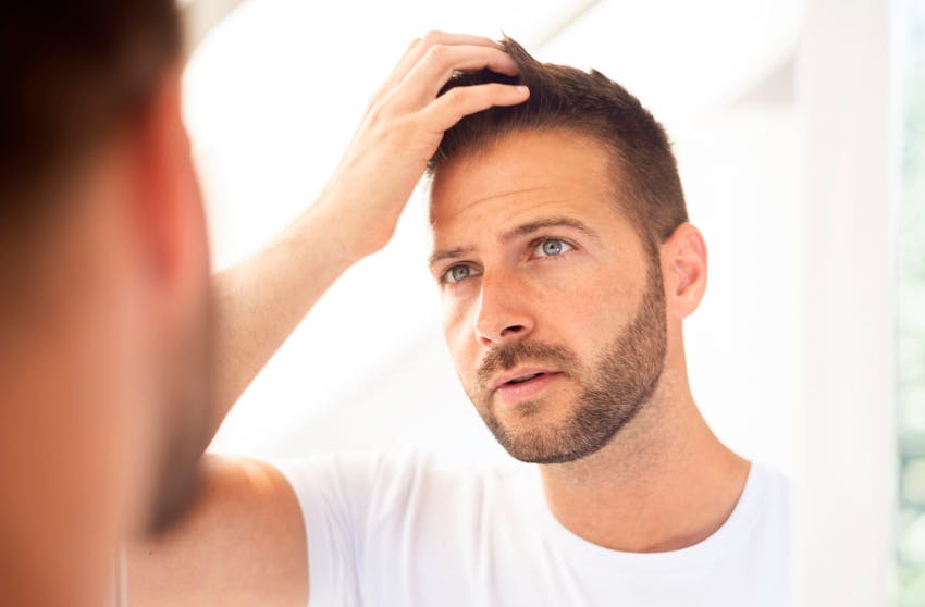 man touching his hair
