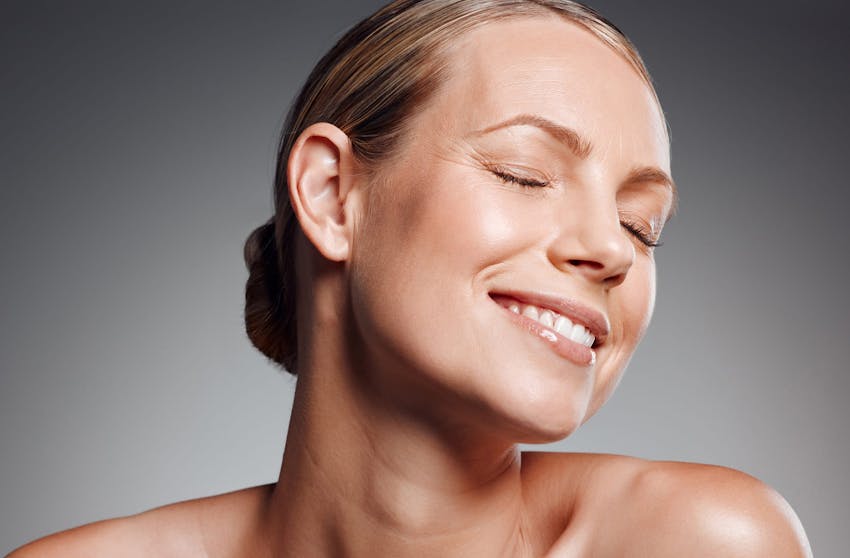 woman smiling with her eyes closed