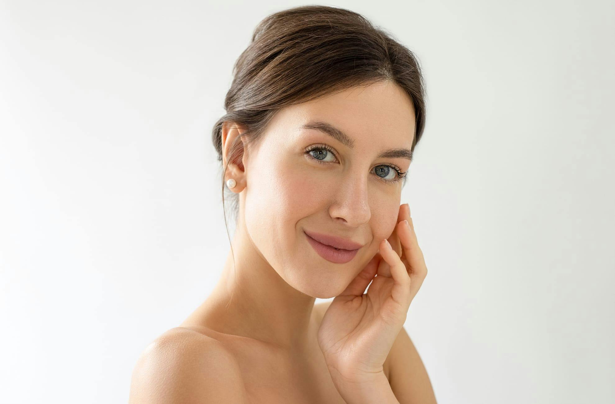 Woman smiling with hand on face