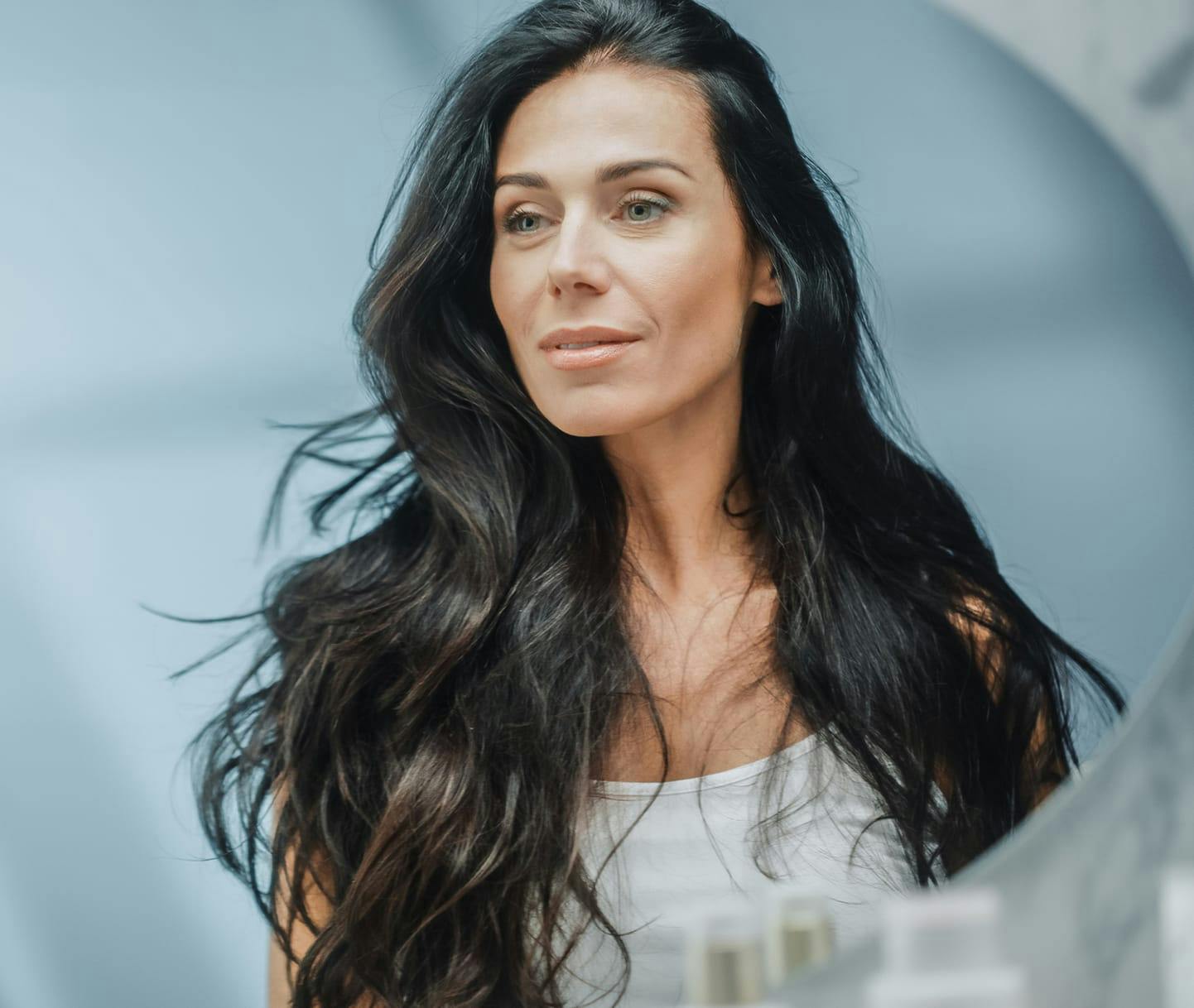 Woman looking in the mirror smiling