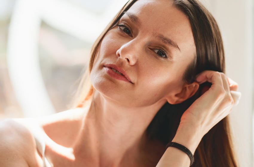 woman pushing her hair behind her ear